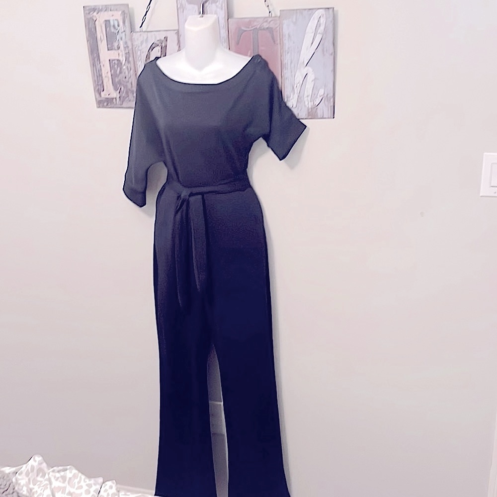 New navy blue jumpsuit size medium. Ties around waste, off on one shoulder.